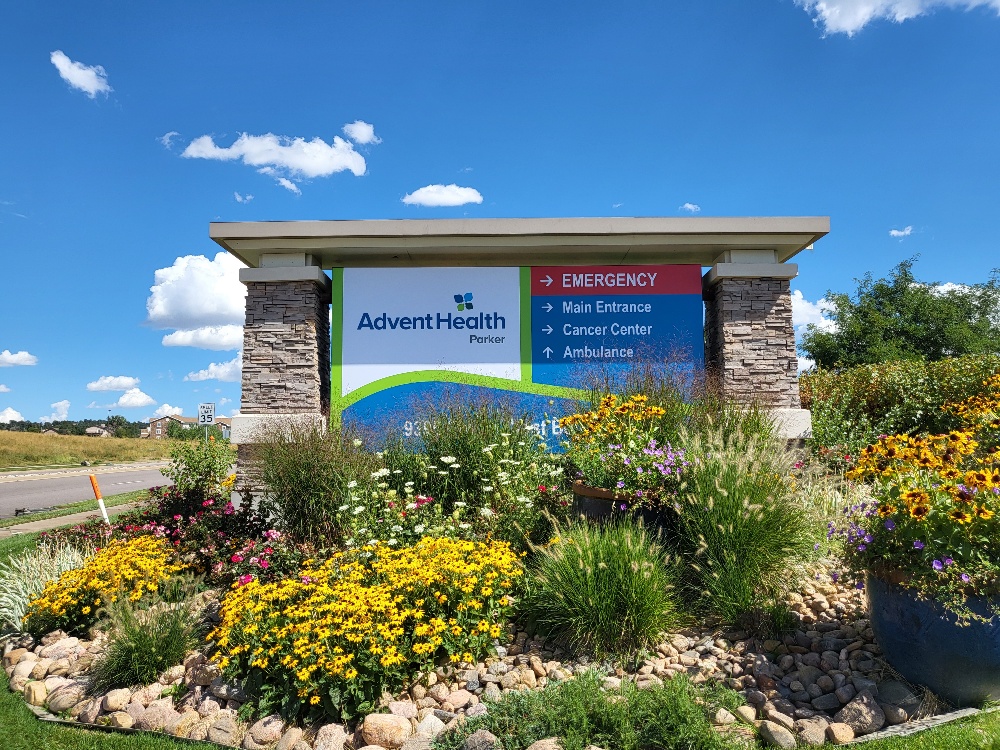 Advent Health Monument Sign with Arrows Pointing in Directions for Emergency, Main Entrance, Cancer Center, and Ambulance