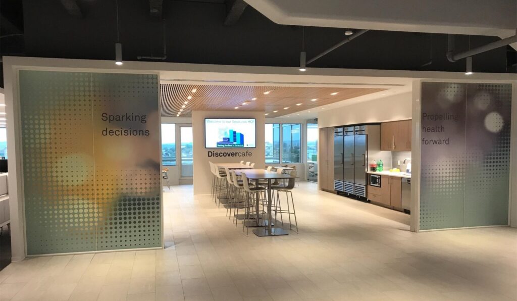 Cafe at a hospital with table and chairs and showcasing graphic walls